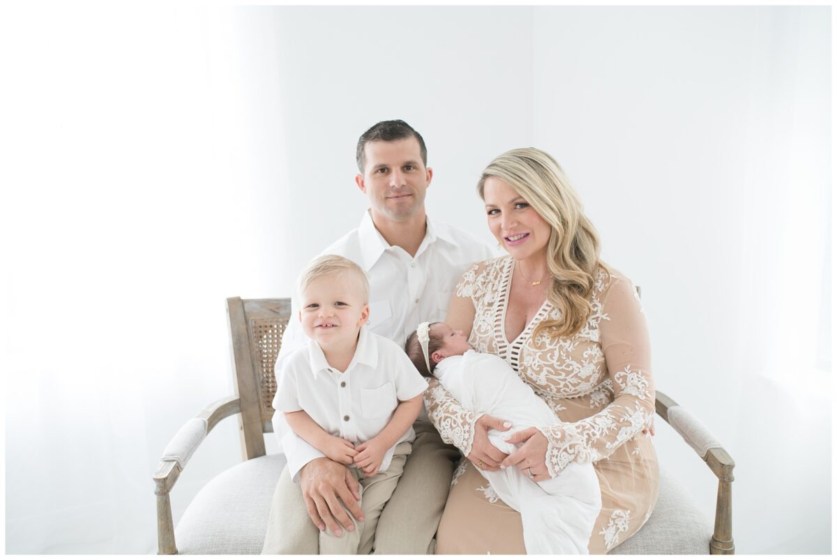 Family of four welcome their newest baby girl for her newborn session